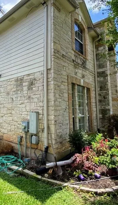 Alt: Home exterior with algae and mildew before soft washing