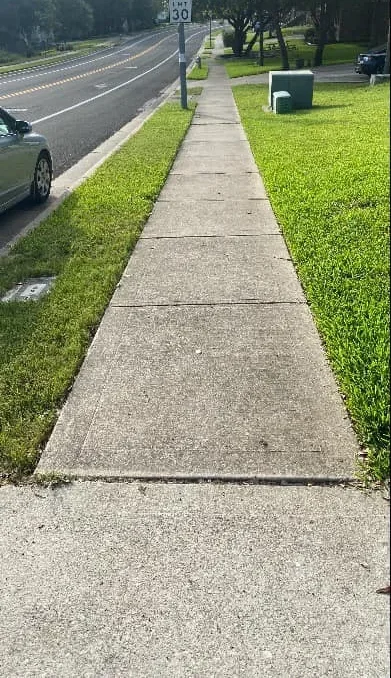 Dirty concrete walkway before professional cleaning